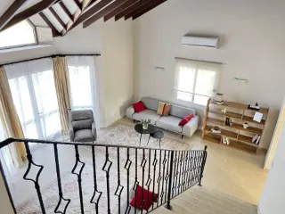 Sarcon 87 renovated villa in North Cyprus – spacious double-height living room with exposed timber beams