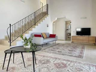 Sarcon 87 renovated villa in North Cyprus – ground-floor living area, wrought-iron staircase, and hallway entrance